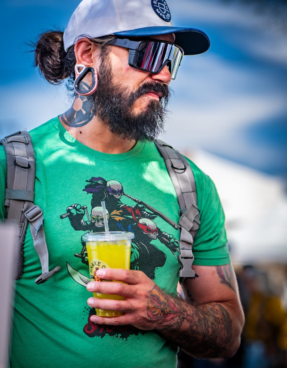 A customer holding a cup of Snake Oil at an outdoor event