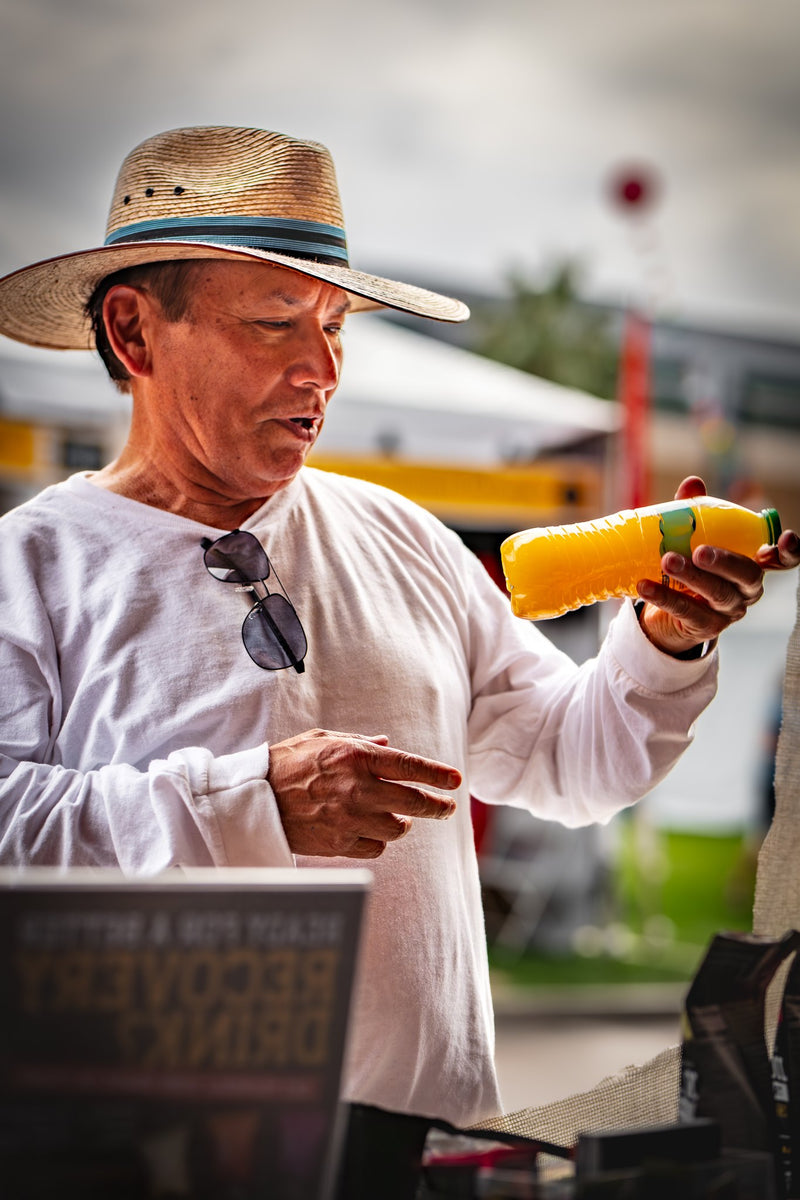 An older customer shaking a freshly poured Elysian Orange outdoors